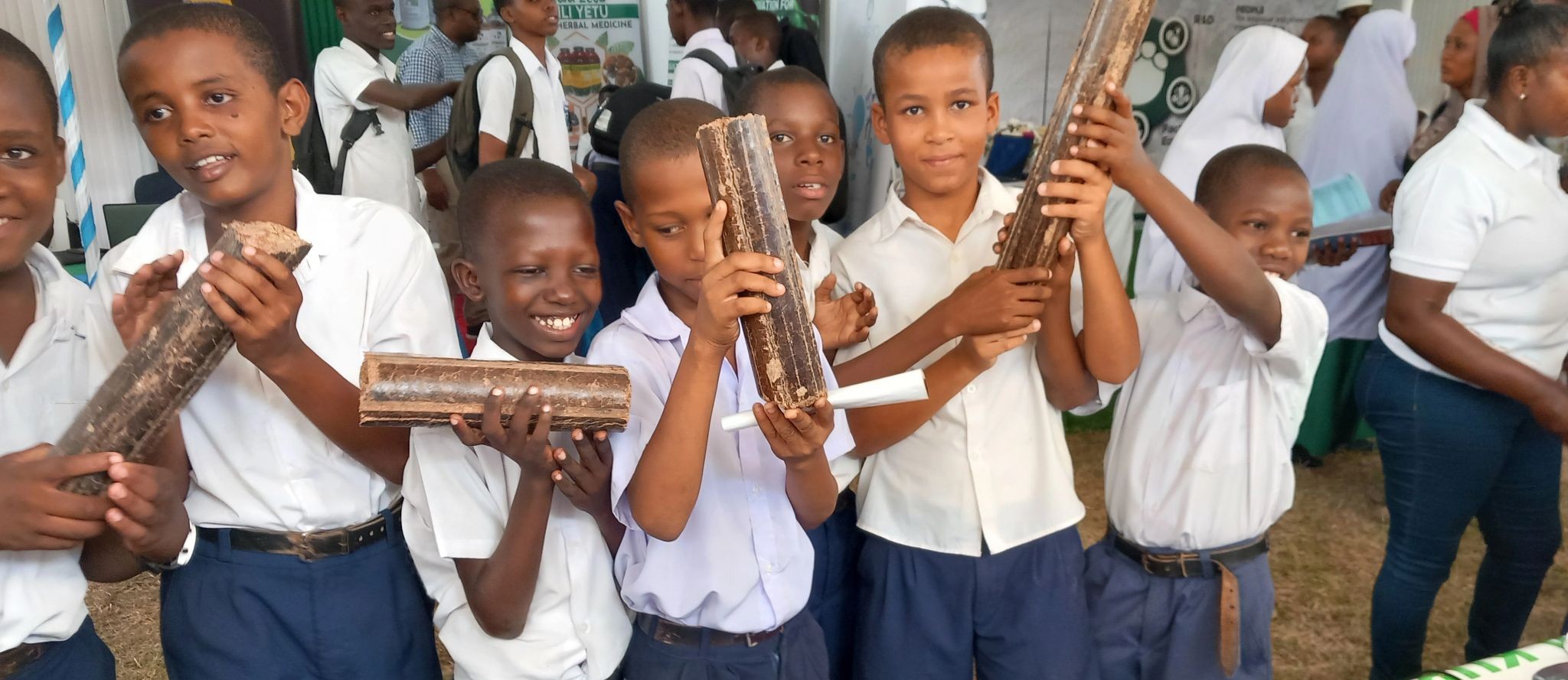 Students-in-uniform-holding-KuniSMART-wood-briquettes